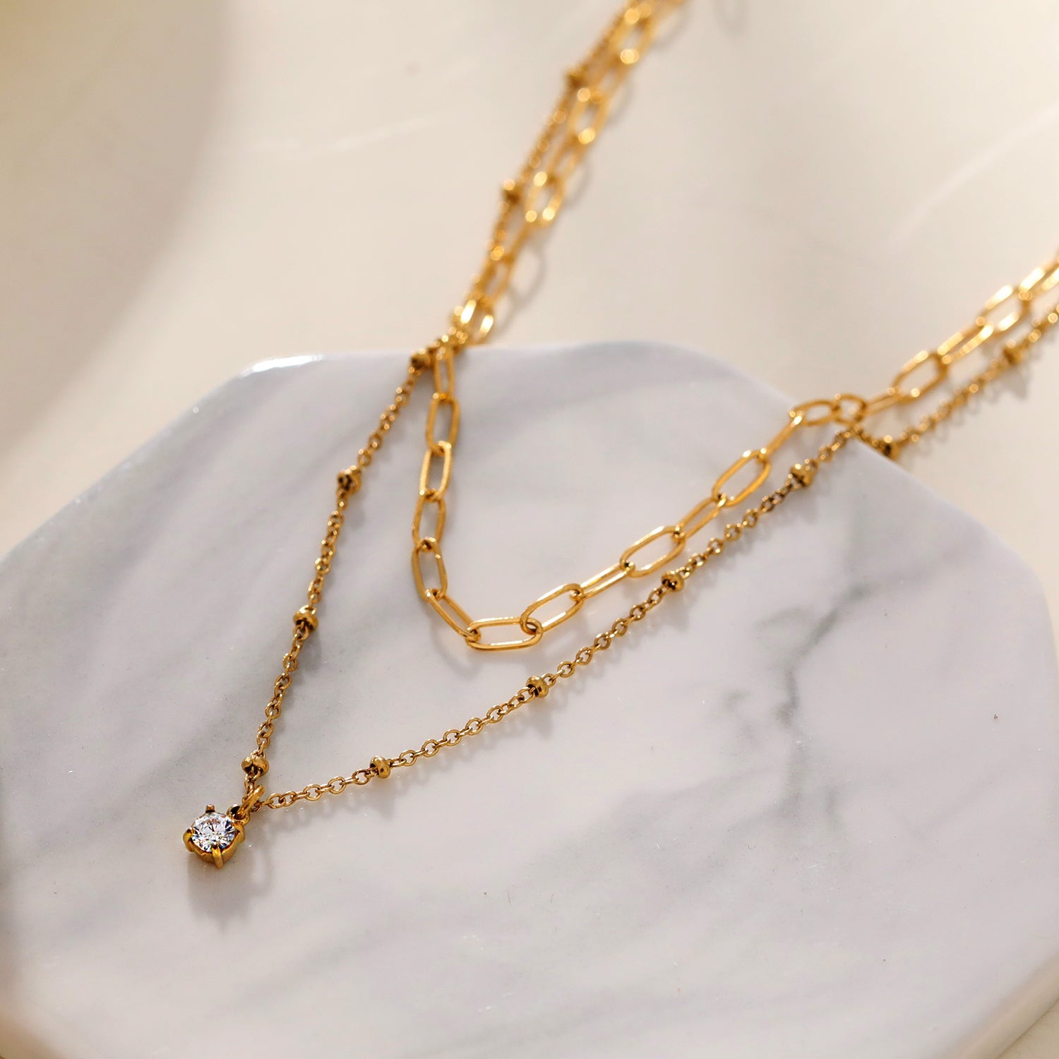 KATERI Gold: Pre-Layered Chains Necklace with a Solitaire Zirconia Charm Pendant.