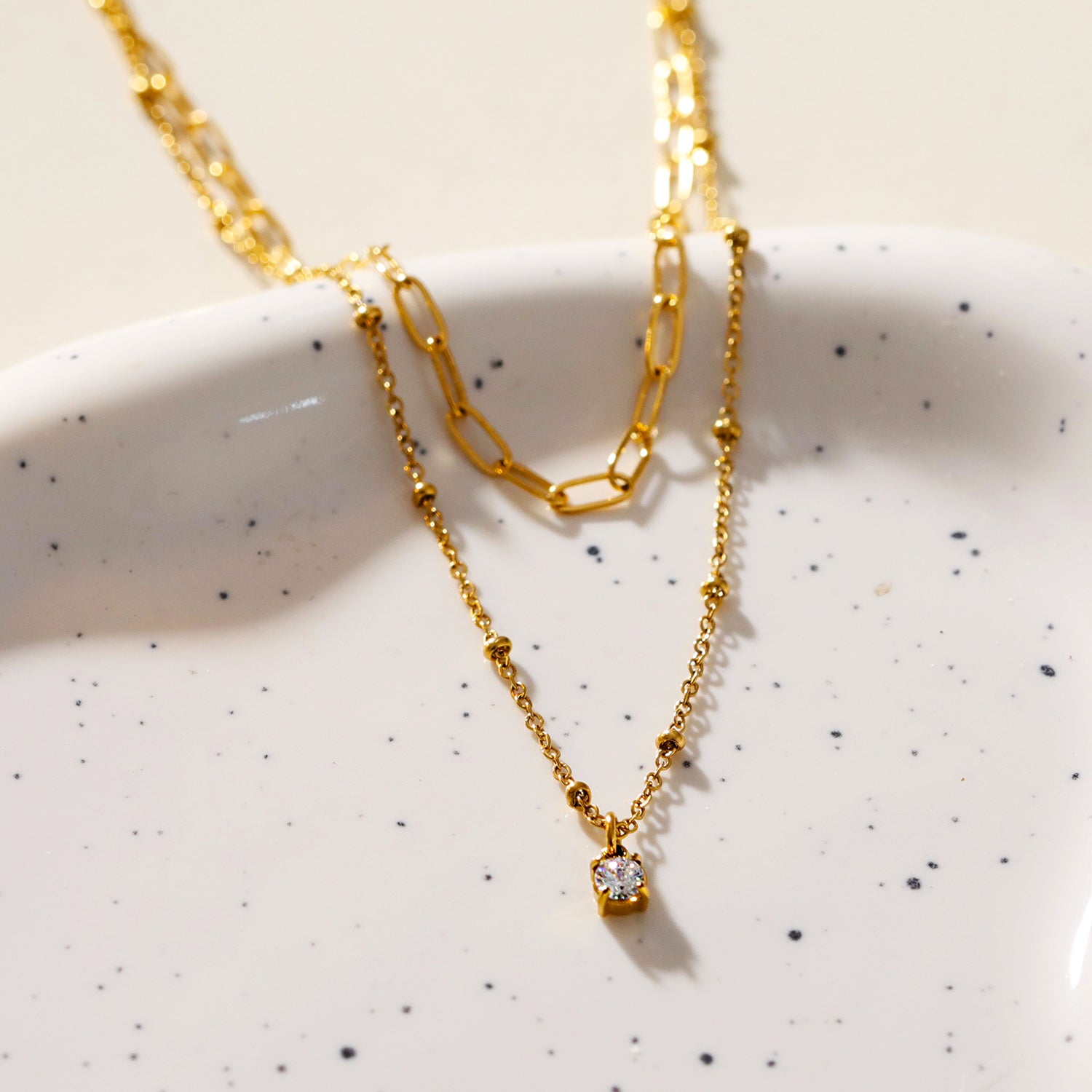 KATERI Gold: Pre-Layered Chains Necklace with a Solitaire Zirconia Charm Pendant.